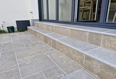 Terrasse et marches extérieures carrelées en pierre beige